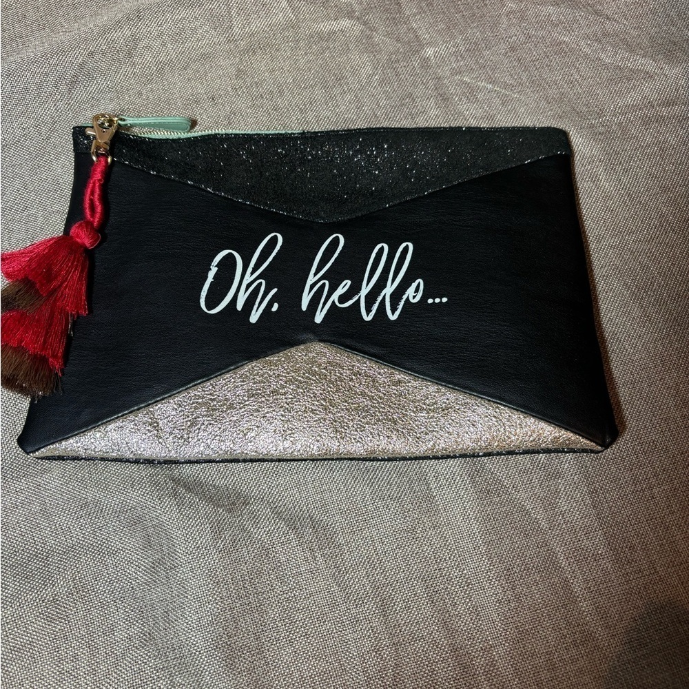 Urban Outfitters Metallic Black, Gold with Tassel “oh, hello” Wristlet Clutch